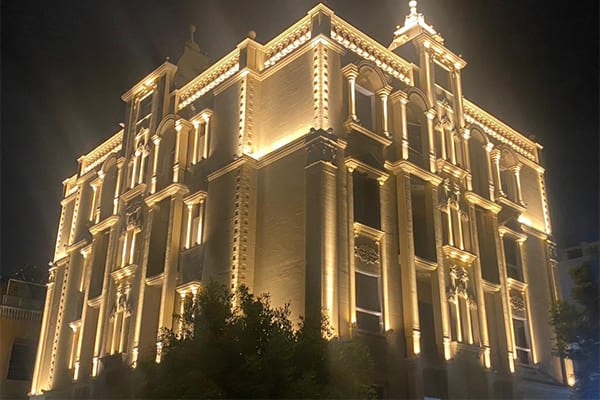 A building facade lit with a mix of wall washer lights and flood lights